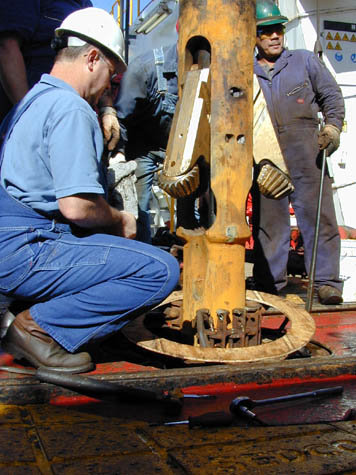 Crew sets up the under reamer to enlarge the hole, 
